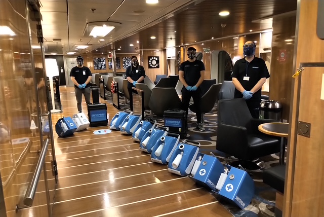 Sanondaf operators with a row of touchless disinfection foggers deployed on board a ship